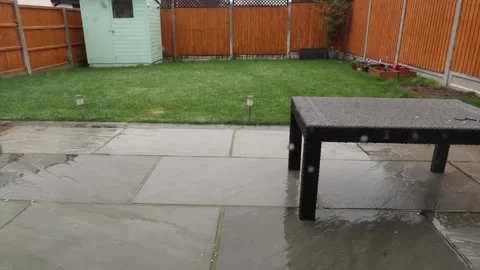 Snow, sleet rain falling and melting in a suburban back garden Stock Footage 148037081