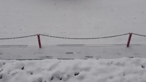Snow Is Slowly Falling On The Pavement And The Road Is Snowing In Winter Stock Footage 93079739