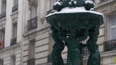Snow slowly falling on a statue in Paris, France Stock Footage 101715690