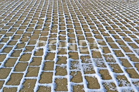 Snow on stone with grass , winter season diversity. Stock Photos