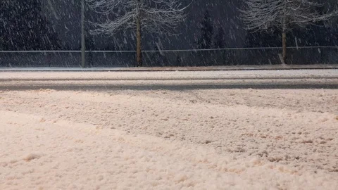 Snow storm beginning at night, icing the roads Stock Footage 123320735