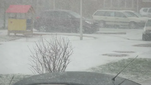 Snow storm in down town.  Snow-covered cars in the city. Snowfall in city, ea Stock Footage 101384924