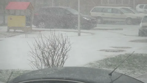 Snow storm in down town.  Snow-covered cars in the city. Snowfall in city, ea Stock Footage 110436658