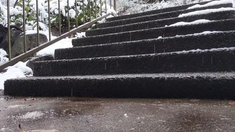 Snow storm falling and covering stone steps outdoors Stock Footage 123321082