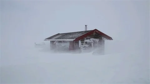 Snow storm hitting a cabin with strong winds Stock Footage 74015676