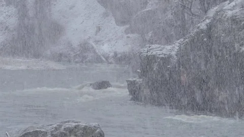 Snow storm over a raging river water in bad weather Stock Footage 73978926