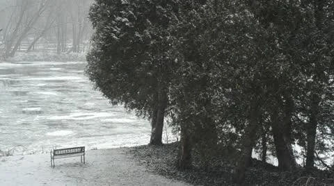 Snow storm with a scenic view over a river flowing with ice Video stock 22201640