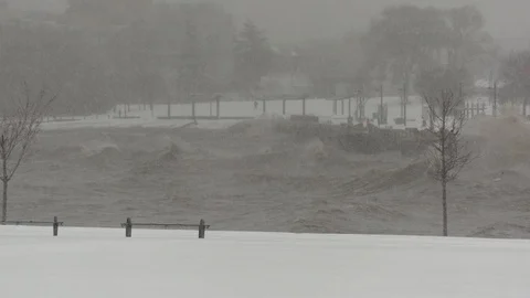 Snow storm with wind and big waves hitting the shore Stock Footage 101497954