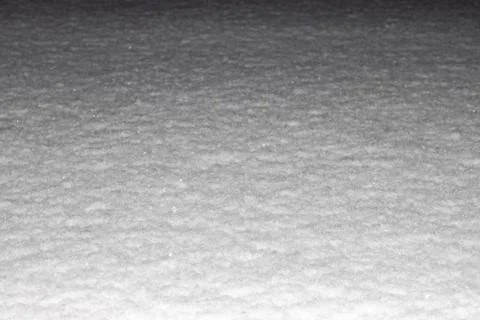 Snow surface illuminated by flash at night, horizontal frame, background for Foto stock