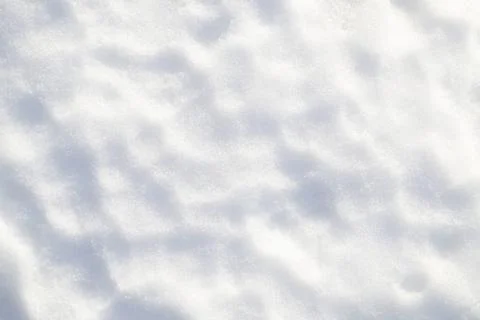 Snow surface in winter with small tubercles close-up. Snow texture. Copy space Stock Photos