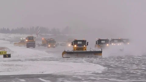 Snow sweepers at airport wide row front view Stock Footage
