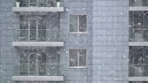 Snow sweeps against the background of the apartment building. Stock Footage 83529082