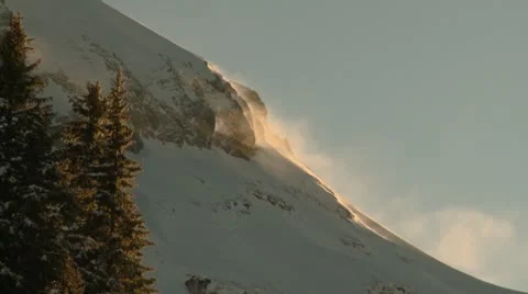 Snow Swirls Off Mountain Side Video stock 10885232