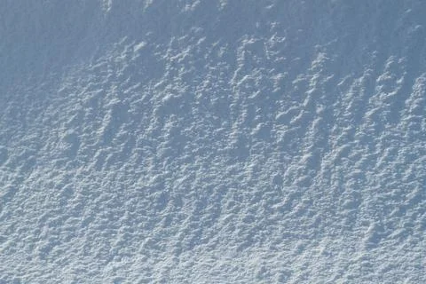 Snow texture. Background of pure blue and white snow. Winter pattern. Stock Photos