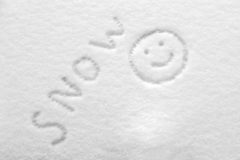 Snow texture is drawn with a smiley face and the inscription snow Stock Photos