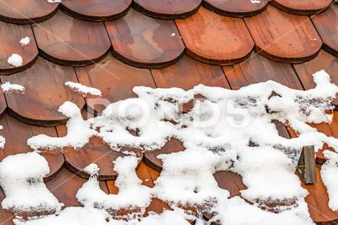 Snow thaws on roof Stock Photos