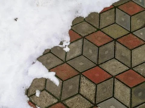 Snow on tile background. Closeup photograph of melting snow on a pavement mad Foto stock