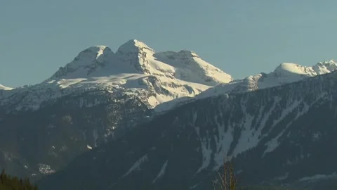 Snow top mountain pull out and pan Video stock 304004978