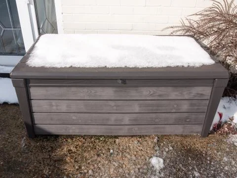 Snow on top of plastic container outside in garden closed locked Stock Photos