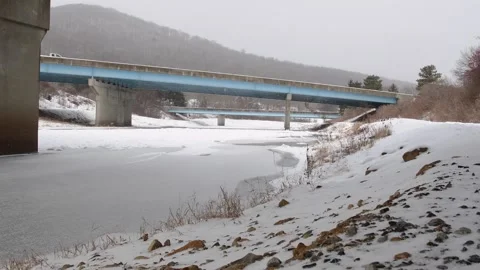 Snow from under a river bridge Stock Footage 262379508