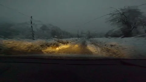 Snow a view of a road trip along the foothills of mountains in snowy weather Stock Footage 301800748
