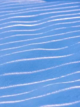 Snow, waves, light and shadow, background. Beautiful winter abstract backgrou Stock Photos