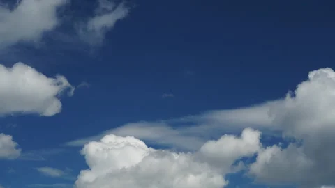Snow-white fluffy clouds move quickly across the blue sky. Timelapse footage. Ba Stock Footage 137102921