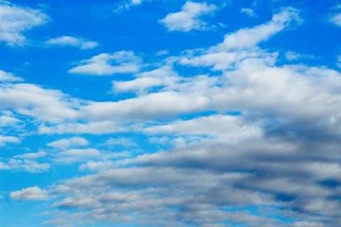 Snow-white light cumulus clouds against a blue sky Stock Photos