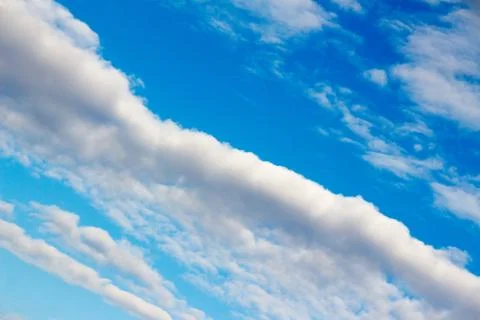 Snow-white light cumulus clouds against a blue sky Stock Photos