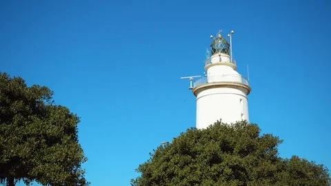 Snow-white lighthouse in Malaga on waterfront Stock Footage 75567342