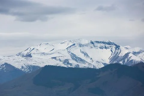 Snow-white mountain peaks Stock Photos