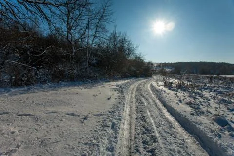 Snow-white winter forest pathways with deep sun and shadows Stock-Fotos