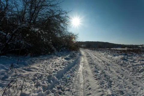 Snow-white winter forest pathways with deep sun and shadows Stock-Fotos