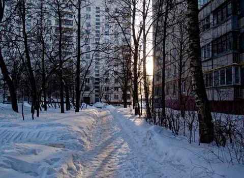 Snow in the yard in the spring in the light of the sun Stock Photos