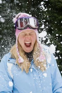 Snowball exploding on young blonde woman 스톡 사진