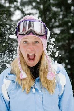 Snowball exploding on young blonde woman Stock Photos