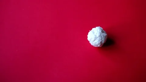 Snowball rolls on red background with copy space. christmas and new year 2022 Stock Footage 166025398