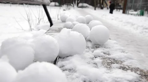 Snowballs lie on a bench Stock Footage 59115687