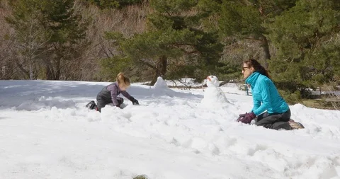 Snowballs war between child and mother Stock Footage 93501728