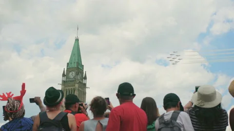 Snowbird jets fly past the Peace Tower during 2016 Canada Day celebrations. Stock Footage 64738344
