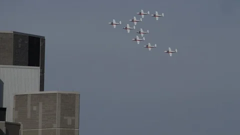 Snowbirds flying high past building in Ottawa Stock Footage 111770153