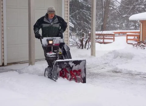 Snowblower Man Moving the Blower Stock Photos