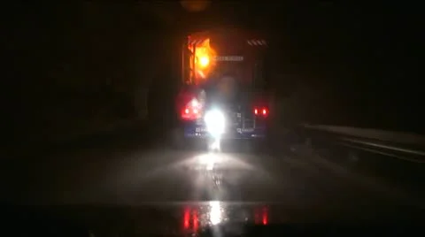 Snowblower with rotating lights on the road at night Stock Footage