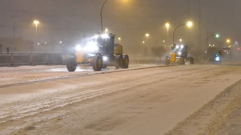 Snowblower speedly passing during snowstorm Stock Footage 125550936