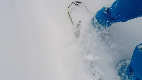 The snowboard digs into the snow Stock Footage 86325510