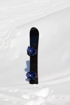Snowboard in snowdrift after snowfall Stock Photos