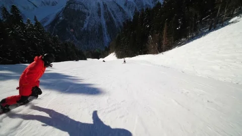 A snowboarder accelerates on a slope and feels freedom and speed in his hair Stock Footage 170647617