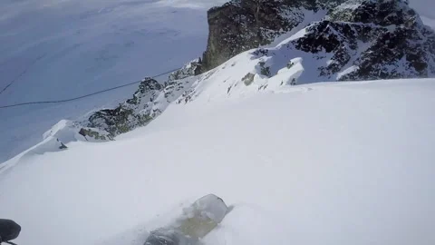 A snowboarder charges down the m Stock Footage 138491510