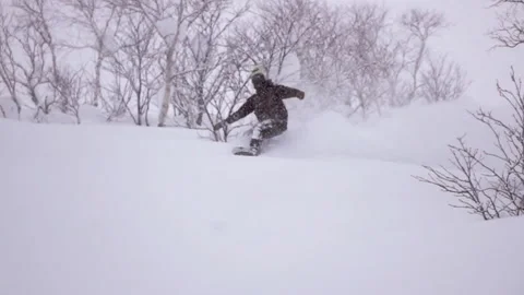 A snowboarder charges down the mountain Stock Footage 138490072