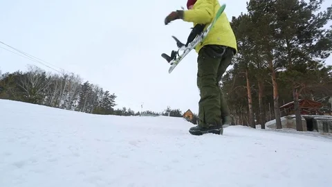 Snowboarder climbs mountain after mountain Stockbeeldmateriaal 73673787